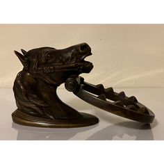 a bronze horse head on top of a metal object