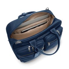 Designed to fit perfectly in the overhead bin, this carry-on is as functional as it is elegant. Its two exterior compartments are ideal for your travel essentials—while its main compartment is roomy enough for your must-have outfits and backups, too. Fits up to a 15" laptop. SKU: P251-5 Laptop Compartment Slip-Through Back Panel INTERIOR FEATURES Cavernous main compartment holds an assortment of items both large and small. Internal organizer with two slip pockets, business card slip pockets, and pen loops. Keep your water bottle secure but accessible with an interior pocket. Tech section in main compartment includes an integrated padded laptop sleeve protects most 15" computers and slip pocket for a tablet. Fabric lining is durable and soft in a contrasting color that makes finding content Rolling Duffle Bag, Hard Shell Luggage, Monogram Luggage, Briefcase Women, Work Backpack, Luggage Shop, Cabin Bag, Luggage Brands, Stationary Gifts