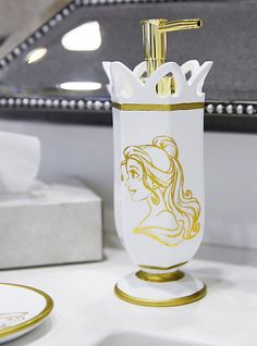 a white and gold bathroom set on a table