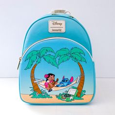 Loungefly Disney Lilo & Stitch Hammock Mini Backpack Brand New With Tags (Nwt) Planning To Have A Relaxing Day At The Beach? Pack All Of Your Essentials Into This Mini Backpack! Get Ready To Kick Back With Lilo & Stitch With A Backpack To Match The Mood. The Duo Are Featured On The Front Zipper Pocket, Lounging On A Hammock Under A Bright Tropical Sky. Comes With Interior Drop Pocket, Antique Brass-Tone Hardware And Adjustable Straps. Rare And Exclusive Edition 8" X 4 1/2" X 10 1/2" Polyurethane Blue Themed Back-to-school Bag, Back To School Vacation Backpack, Themed Travel Bags For Back To School, Disney Travel Backpack, Blue Backpack For Disney Trips With Adjustable Strap, Disney Style Backpack For Travel, Blue Backpack With Adjustable Strap For Disney Trips, Blue Themed School Bags, Themed Blue School Bags