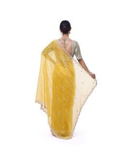 Look like a royalty in this exquisite yellow embroidered organza silk saree at weddings and special occasions. It comes with a beautiful sage green embroidered blouse. Yellow Organza Pre-draped Saree For Reception, Yellow Chanderi Saree For Reception, Yellow Silk Pre-draped Saree For Reception, Yellow Fitted Organza Pre-draped Saree, Yellow Dola Silk Pre-draped Saree For Reception, Yellow Silk Saree For Reception, Yellow Chikankari Embroidery Saree For Reception, Yellow Fitted Pre-draped Saree With Chikankari Embroidery, Fitted Yellow Pre-draped Saree With Chikankari Embroidery