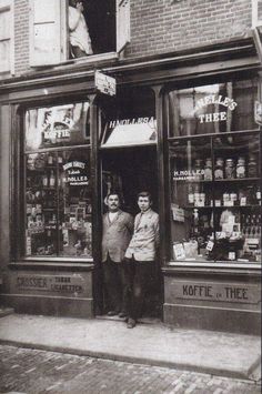 two men are standing in the doorway of a store