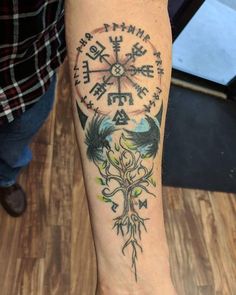 a person with a compass tattoo on their arm