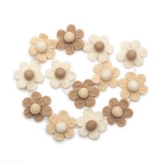 wool felt flowers arranged in a circle on a white background with copy space for text