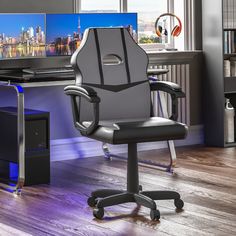 an office chair sitting in front of a computer desk with a monitor and keyboard on it