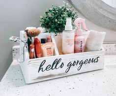 a white wooden box filled with personal care items on top of a bathroom counter next to a mirror