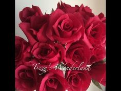 a vase filled with red roses on top of a table