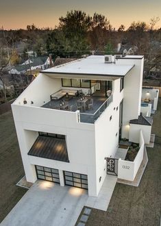 an aerial view of a modern house in the evening