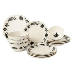 black and white dinnerware set with leaves on the front, including one bowl, two plates