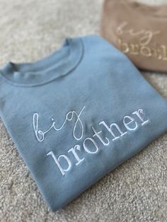 The perfect touch to reveal your new arrival to a sibling 🫶🏼 Perfect to get the older siblings excited about their new arrival!  When I was pregnant with my second son, my son loved wearing his big brother tshirt proudly and was so excited when he read it himself to find out about his new baby sibling 🤍 Can also be made to say 'big sister' aswell as 'little brother' or 'little sister' for the baby to match 🤍 (Please see other listings in my shop as I can't have them all under one item!) 100% Upgraded To Big Brother, Big Brother Embroidered Shirt, Gift From Baby To Sibling, Blue T-shirt For Gender Reveal On Father's Day, Blue T-shirt For Father's Day Gender Reveal, Personalized Crew Neck T-shirt For Gender Reveal, Older Sibling Pregnancy Announcement, Baby Brother Announcement, Big Brother Shirt Announcement