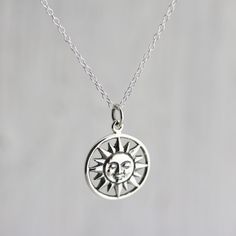 Sterling Silver Smiling Sun Charm Necklace. The largest object visible in our vast sky, the sun is the source of light, heat, and life. Feel the warmth of the sweet, smiling sun face in this classic celestial design. » Sterling Silver Smiling Sun Charm (21.5mm including jump ring x 15.25mm) » Sterling Silver Cable Chain (select from drop-down on upper right) » Your jewelry purchase will come beautifully packaged for gift giving. Personalize It: ✧ Add a Birthstone Crystal: http://etsy.me/2v0gADY Silver Celestial Necklace With Sun Design, Spiritual Silver Necklace With Sun Design, Symbolic Silver Necklace With Sun Design, Celestial Sterling Silver Necklace With Sun Design, Silver Sun Necklace With Sun And Moon Design, Silver Necklace With Sun And Moon Design, Silver Sunburst Necklace For Gift, Sterling Silver Sun Design Necklace, Smiling Sun