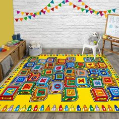 a child's room with a large rug on the floor and toys in front of it