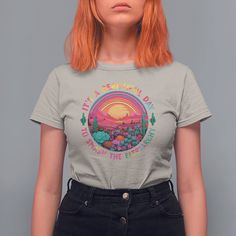 a woman with red hair wearing a t - shirt that says, it's a nice day in the desert