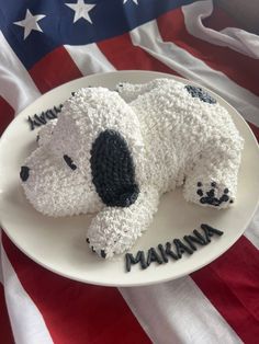 a cake shaped like a dog laying on top of a plate