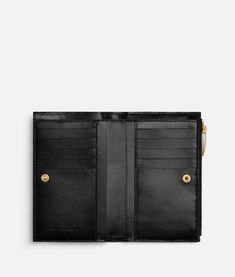 "Find BOTTEGA VENETA Medium Intrecciato Bi-fold Zip Wallet on Editorialist. Intrecciato leather wallet. Ten card slots, one bill compartment, four additional pockets, one zippered coin purse. Press-stud closure. Lining: Calfskin. Color: Black. Hardware: Gold finish. Height: 9,3 cm | 3.6\". Width: 14,5 cm | 5.7\". Depth: 2 cm | 0.8\". • Material: Lambskin, Calfskin." Oil Shop, Bottega Veneta Belt, Versace Wallet, Balenciaga Belt, Celine Wallet, Bottega Veneta Wallet, Cartier Men, Wallet Gifts, Zip Wallet