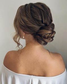 a woman with her hair in a low bun