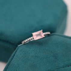 Natural Rose Quartz Emerald Cut Ring, Pink Quartz Engagement Ring, Promise Ring, Crystal Ring, Valentine's Day Jewelry Gift for Couple  ❥ RING DESCRIPTION :- ✦ Handmade, high-quality item! ✦ Material: SOLID 14K/18K/24K GOLD (can be made in white/rose/yellow gold) ✦ Center Stone:  Rose Quartz ✦ Stone Shape: Emerald Shape Facet Cut ✦ Dimensions:- 7 X 5 MM ✦ Color: Pink ✦ Side Stone: Cubic Zirconia  ✦ Color: Transparent ✦ Clarity: Eye Clean  ❥ FINISHES :- ✦ 925 Sterling Silver, 22k Yellow Gold, Rose Gold, White Gold or Black Gold Plating.  ❥ NOTE :-  ✦ Due to the nature of the gemstones, the appearance of each piece may slightly vary in color. ✦ The shades of each Rose Quartz vary since they are natural and untreated. If you have a shade preference, please indicate it in the notes section. ✦ Rose Quartz Wedding, Quartz Engagement Ring, Ring Emerald Cut, Ring Crystal, Stone Rose, Emerald Cut Rings, Wedding Engagement Ring, Couple Ring, Ring Emerald