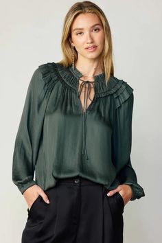 A gathered yoke and layered ruffles at the shoulders heighten the feminine charm of this breezy blouse. It's cut for a loose, relaxed silhouette and features a split neckline, self-tie detailing, and long sleeves with elasticized cuffs.  •Split neckline with self-tie •Gathered yoke •Ruffle trim •Long sleeves with elast Chic Flowy Blouse With Split Neck, Chic Flowy Split Neck Blouse, Billowy Long Sleeve Peasant Top With Ruffles, Casual Ruffled Split Neck Blouse, Casual Blouse With Gathered Sleeves And Ruffled Collar, Elegant Long Sleeve Smocked Top For Fall, Feminine Long Sleeve Peasant Top With Ruffles, Long Sleeve Smocked Top With Ruffles For Brunch, Fall Feminine Blouse With Smocked Bodice