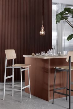 two bar stools in front of a counter with drinks on it