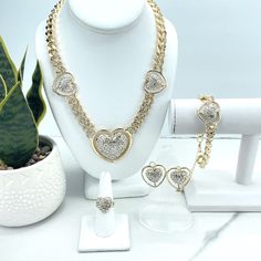 18k Gold Filled Iced Curb Link Chain with CZ Heart Charms Set, Necklace, Bracelet, Earrings & Ring, Wholesale Jewelry Making Supplies.Set Size:Necklace: -Length: 19 inches + 3.3 inches extender | Width: 13mm | Big heart: 47mm x 45mm | Medium Hearts: 26mm x 23mmBracelet:-Length: 8 inches + 3.2 extender | Width: 13mm | Heart: 26mm Earrings: 27mmRing :-Thickness: 4mm | Hand Width: Adjustable | Hand Thickness: 17mm Valentine's Day Wedding Jewelry Chain, Valentine's Day Wedding Chain Jewelry, Heart-shaped Chain Jewelry For Weddings, Gold Double Heart Chain Jewelry, Double Heart Gold Chain Jewelry, Heart Shaped Gold Plated Chain Jewelry, Gold Crystal Heart Pendant Jewelry, Valentine's Day Anniversary Chain Jewelry, Gold Heart Pendant Jewelry With Bling