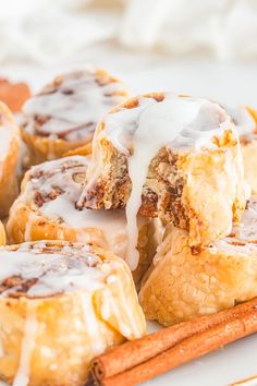 cinnamon rolls with icing and cinnamon sticks