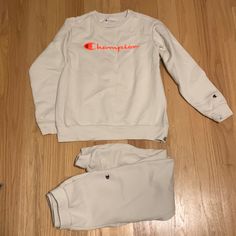 Champion Kids Large Sweatshirt/Medium Sweatpants Beige Neon Orange Set Never Worn Dry Cleaned White Crew Neck Set For Winter, Fall White Crew Neck Sets, White Fleece Long Sleeve Tracksuit, White Long Sleeve Tracksuit With Letter Print, White Tracksuit With Letter Print For Loungewear, White Fleece Tracksuit With Ribbed Cuffs, White Letter Print Tracksuit For Loungewear, White Crew Neck Tracksuit For Loungewear, White Tracksuit For Loungewear