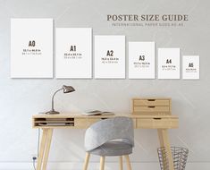 a poster size guide on the wall next to a desk