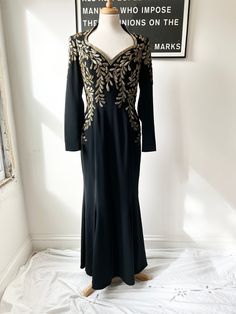 a black dress with gold embroidery on it