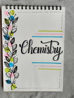 a spiral notebook with the word'chemistry'written in cursive writing on it