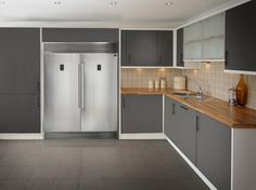 a kitchen with gray cabinets and white walls