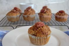 a muffin sitting on top of a white plate next to other muffins