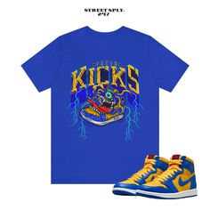 Fresh Kicks Monster T Shirt to Match 1 Reverse Laney High Varsity Maize Game Royal UCLA Dunk This classic unisex jersey short sleeve tee fits like a well-loved favorite. Soft cotton and quality print make users fall in love with it over and over again. These t-shirts have-ribbed knit collars to bolster shaping. The shoulders have taping for better fit over time. Dual side seams hold the garment's shape for longer.  .: 100% Airlume combed and ringspun cotton (fiber content may vary for different Throwback Short Sleeve Pre-shrunk T-shirt, Throwback Short Sleeve Tops For Sports, Throwback Short Sleeve Tops For Sports Events, Yellow Team Spirit T-shirt With Graphic Print, Throwback Fan Merchandise T-shirt With Short Sleeves, Throwback Short Sleeve Fan Merchandise T-shirt, Throwback Short Sleeve Team Name T-shirt, Blue Throwback Sports T-shirt, Throwback Short Sleeve T-shirt With Team Name