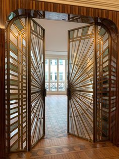 an open wooden door with glass panels on the inside and outside, in front of a brick floor