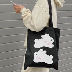 "Coming in 2 different colors, natural and black, with a super cute and simple bunny design, this canvas tote bag is a perfect complement to your daily outfit ୨୧🐇 ♡ More of Coquette Aesthetic: https://www.etsy.com/shop/RainieshopDesign?ref=seller-platform-mcnav§ion_id=1 ☁️ 𐙚 . ˙ PRODUCT DETAILS 𖧧 ₊ ˚ 🐇 ♡ 100% cotton canvas ♡  Heavy fabric (12 oz/yd² (406.9 g/m ♡ Sewn-in label ♡ One size -15\" x 16\" (handles are 20\" long) ☁️ 𐙚 . ˙ CARE INSTRUCTIONS 𖧧 ₊ ˚ 🐇 ▸ Hand wash ▸ Tumble dry: low h Black Tote Bag Aesthetic, Bunny With Bow, Minimalist Tote, Funky Glasses, Tout Rose, Bunny Design, Bunny Designs, Bags Aesthetic, Cute Tote Bags