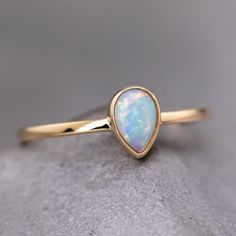 Minimalist Pear Shaped Opal Ring Teardrop Opal Ring, Minimalist Opal Ring For Formal Occasions, Fine Jewelry Opal Ring With Round Band, 14k Gold Pear Shaped Ring Gift, Elegant Teardrop Opal Ring As Gift, Opal Ring With Bezel Setting Gift, Pear Shaped Yellow Gold Rings For Gift, Pear-shaped 14k Gold Ring As Gift, Elegant Teardrop Opal Ring Gift