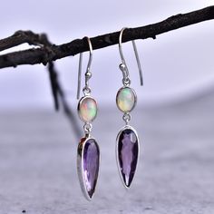 ✦ These Eye catchy luxurious Amethyst and Opal cocktail dangle earrings in sterling silver is one of a kind due to natural crystals and simple yet elegant design. These earrings are handmade with natural Amethyst and Opal, making them a truly unique and stunning piece of jewelry. The healing properties of these stones are said to promote relaxation, peace, and calmness - perfect for when you need to unwind after a long day.  Whether you're dressing up for a special occasion or just looking to ad Elegant Purple Jewelry With Ear Wire, Elegant Purple Earrings As A Gift For Her, Elegant Purple Earrings For Her, Elegant Long Drop Purple Jewelry, Elegant Purple Long Drop Jewelry, Purple Long Drop Jewelry For Gift, Purple Long Drop Earrings For Gift, Amethyst Dangle Earrings For Anniversary, Purple Sterling Silver Drop Earrings