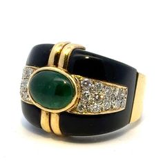 Fabulous emerald, diamond, and onyx cocktail ring handcrafted in 18 karat yellow gold. The band features a bezel set oval cabochon green emerald weighing approximately 4.00 carats, 24 round briliant cut diamonds weighing approximately 2.50 carat total weight, and onyx accent. The diamonds are graded H-I color and SI clarity. The ring measures 19.5mm in width tapering down to 6.5mm, and is currently size 8.5 (can be sized). Weight: 18.4 grams. Yellow Gold Cocktail Ring, Gold Cocktail Ring, Gold Cocktail, Vintage Cocktail, Diamond Rings Bands, Green Emerald, Diamond Band, Emerald Diamond, Oval Cabochon