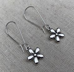 "These sweet and dainty flower dangle earrings might be little in design but they are eye catching and timeless. The perfect everyday earrings for any nature lover. Perfect for Spring and Summer! The earrings measure 3/8\" long by 3/8\" wide and are made from plated silver. They hang from kidney style ear wires that lock and latch. Overall drop length is 1 3/8\". I have a matching necklace in my shop, if you would like the whole set. Here is a direct link Thanks for stopping by! Please take a mo Delicate Nickel-free Dangle Flower Earrings, Delicate Hypoallergenic Dangle Flower Earrings, Dainty Dangle Flower Earrings For Everyday, Delicate Everyday Flower-shaped Earrings, Everyday Flower Charm Drop Earrings, Nickel-free Drop Flower Earrings For Everyday Wear, Dainty Dangle Flower Earrings Nickel Free, Everyday Dangle Earrings With Flower Charm, Dainty Adjustable Flower Earrings