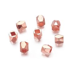 pink crystal beads are arranged on a white surface