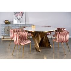 a dining room table with pink chairs around it