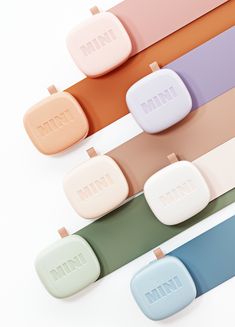 five pastel mini cases are lined up on top of each other in different colors