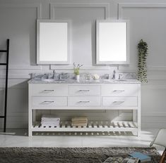 a bathroom vanity with two mirrors above it