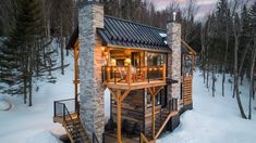 a small wooden cabin in the middle of snow covered ground with stairs leading up to it