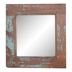 an old wooden mirror with peeling paint on the side and a white frame around it