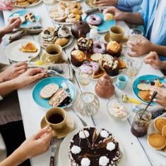 a group of people sitting around a table eating food