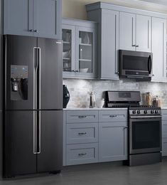 a kitchen with gray cabinets and stainless steel appliances, including an oven, refrigerator, microwave, dishwasher and stove