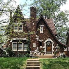 a brick house with steps leading up to the front door