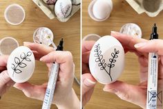 someone is painting an egg with flowers on it and another person is holding a marker