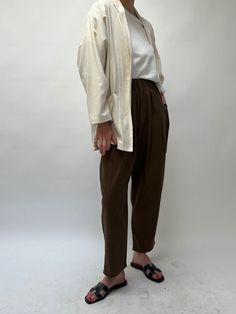 The versatile Lena Pant, created in our durable and cozy silk canvas, is an essential addition to any wardrobe. Boasting a comfortable elastic waist, attractive front pleats, convenient side pockets, and a stylish cropped leg, the Lena Pant is perfect for any occasion. Our highly sought-after Lena Pant is now even more luxurious with its new design in pure silk, maintaining the same trusted quality and texture. 100% Silk Made in USA Available in 26" inseam and 29" ( Full Length ) *If you’re in-b Beige Relaxed Fit Harem Pants For Fall, Relaxed Fit Bottoms With Pleated Waist For Daywear, Spring Parachute Pants With Elastic Waistband For Everyday, Effortless Pants With Loosely Fitted Hips And Tapered Leg, Relaxed Ankle-length Work Pants, Effortless Straight Leg Pants For Daywear, Tapered Leg Pants With Elastic Waistband For Daywear, Oversized Bottoms With Pockets For Daywear, Oversized Ankle-length Pants For Workwear