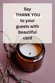 a candle sitting on top of a table next to some dried flowers and a card that says, say thank you to your guests with beautiful card